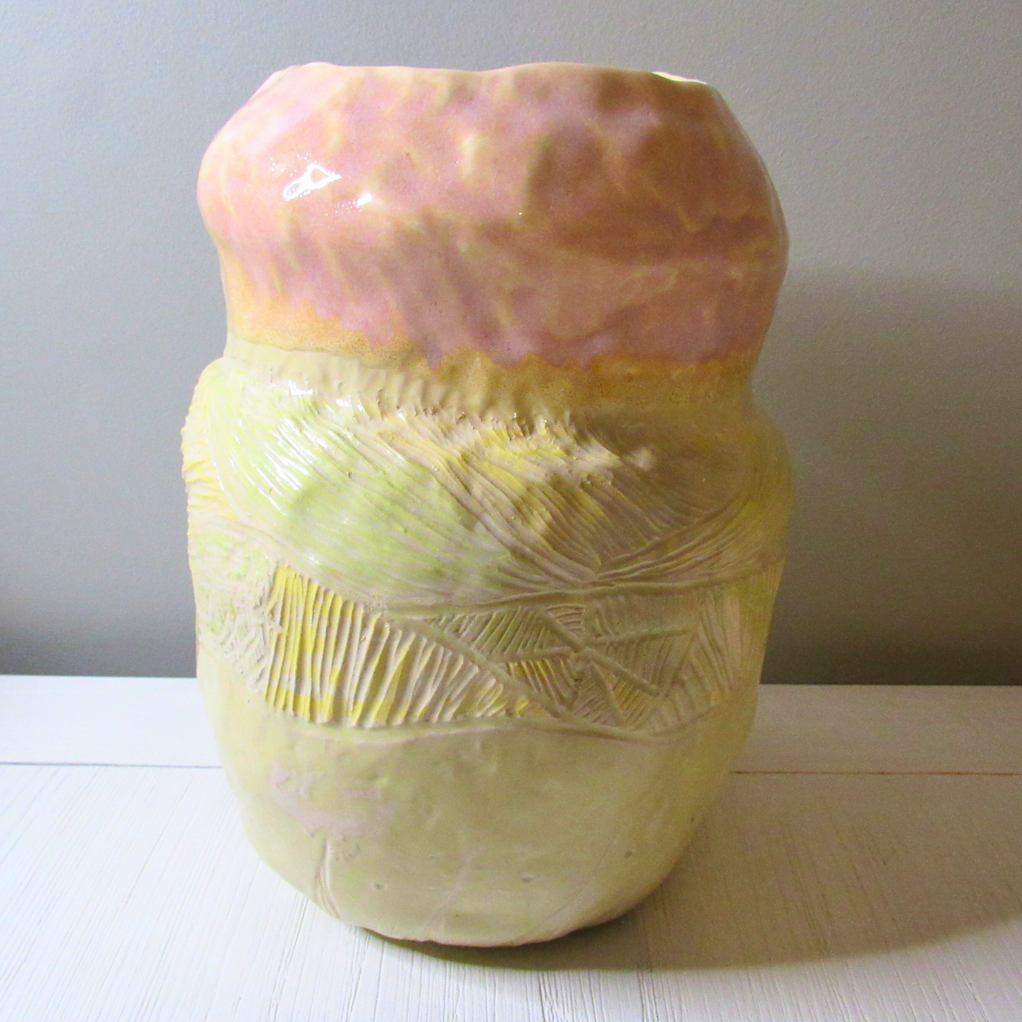 pink and yellow ceramic coil pot
