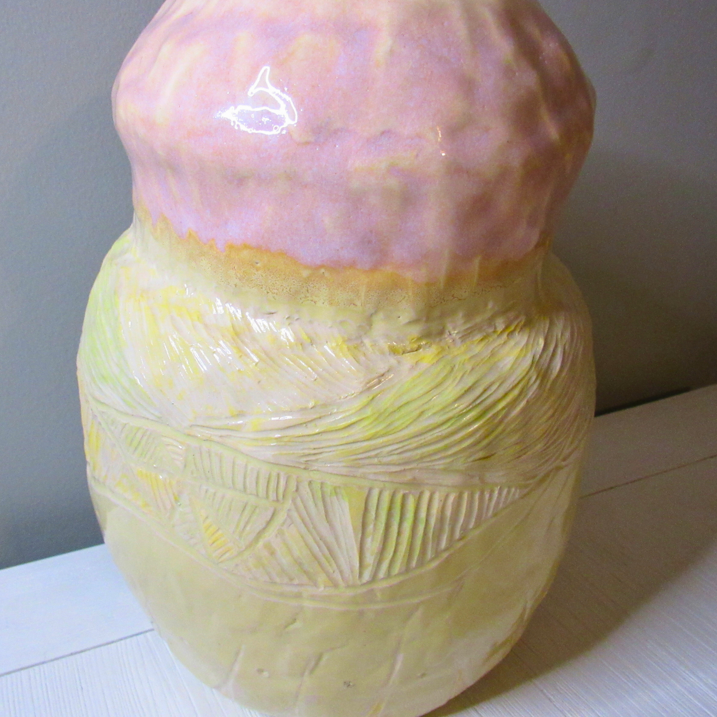 pink and yellow ceramic coil pot