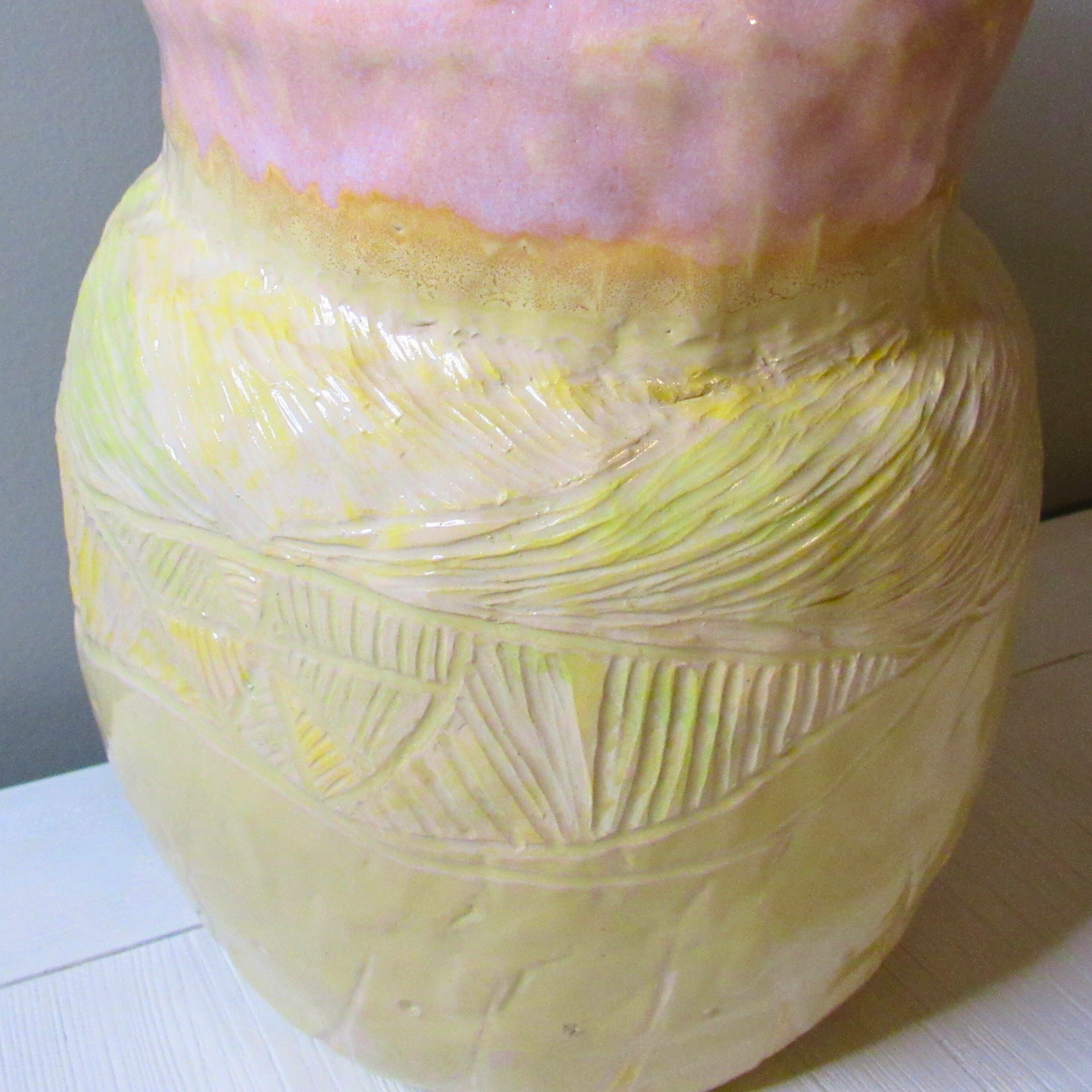 pink and yellow ceramic coil pot