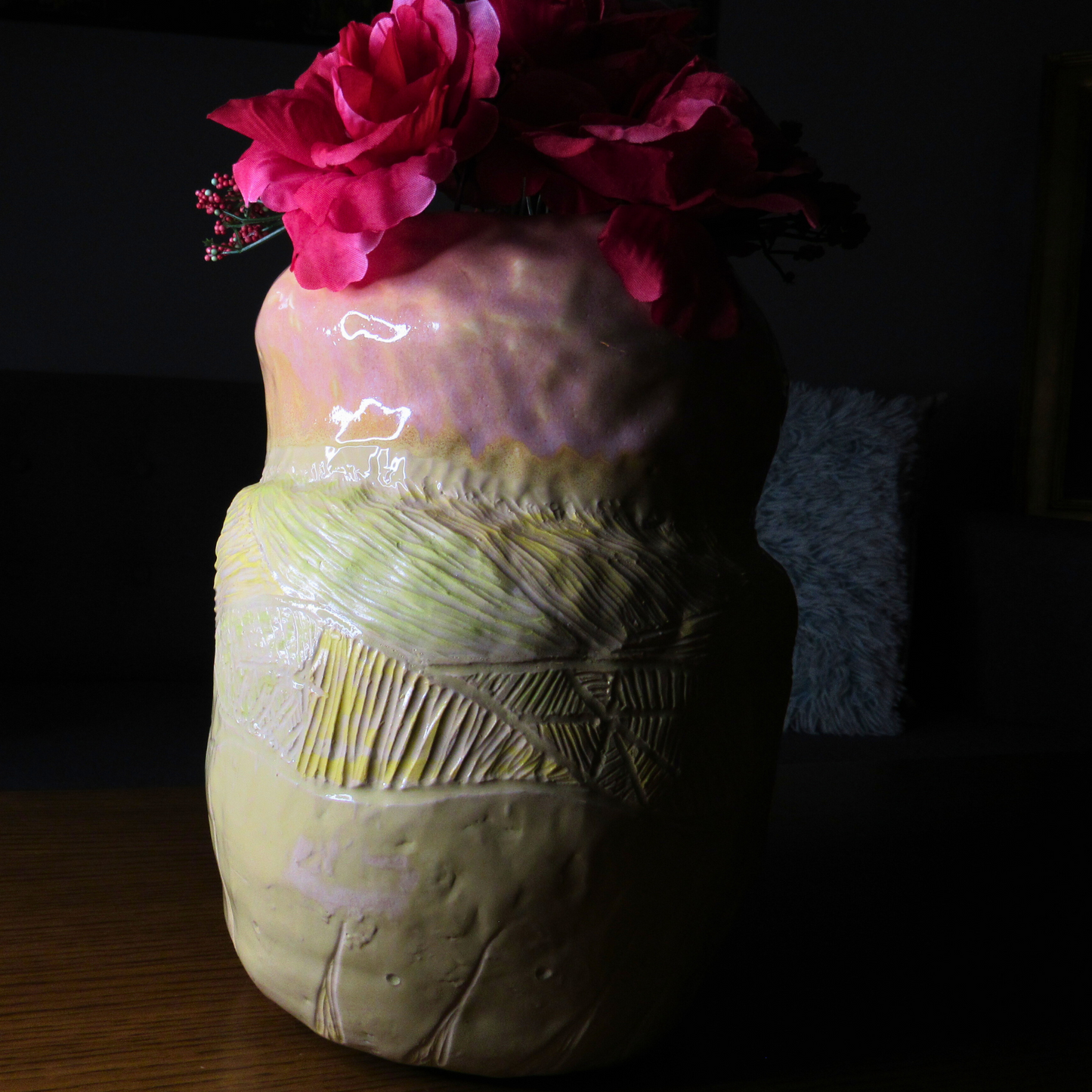pink and yellow ceramic coil pot used as a vase