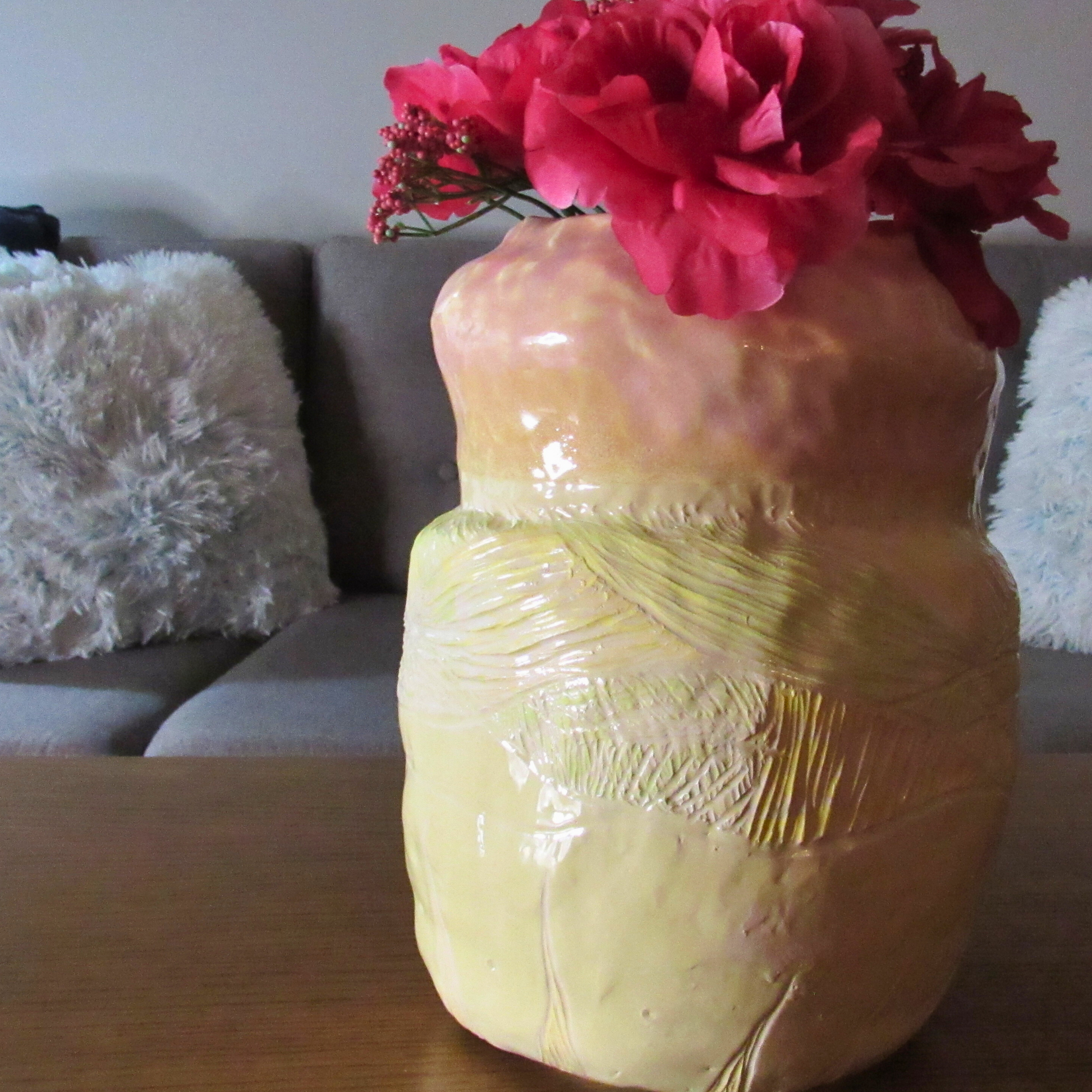 pink and yellow ceramic coil pot used as a vase